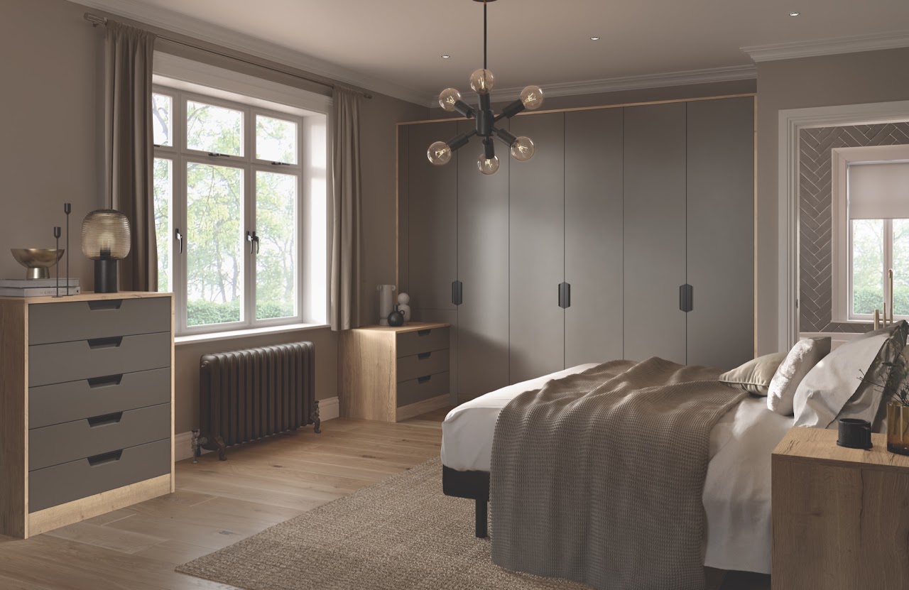 Neutral bedroom with bed, rug and coordinated fitted furniture