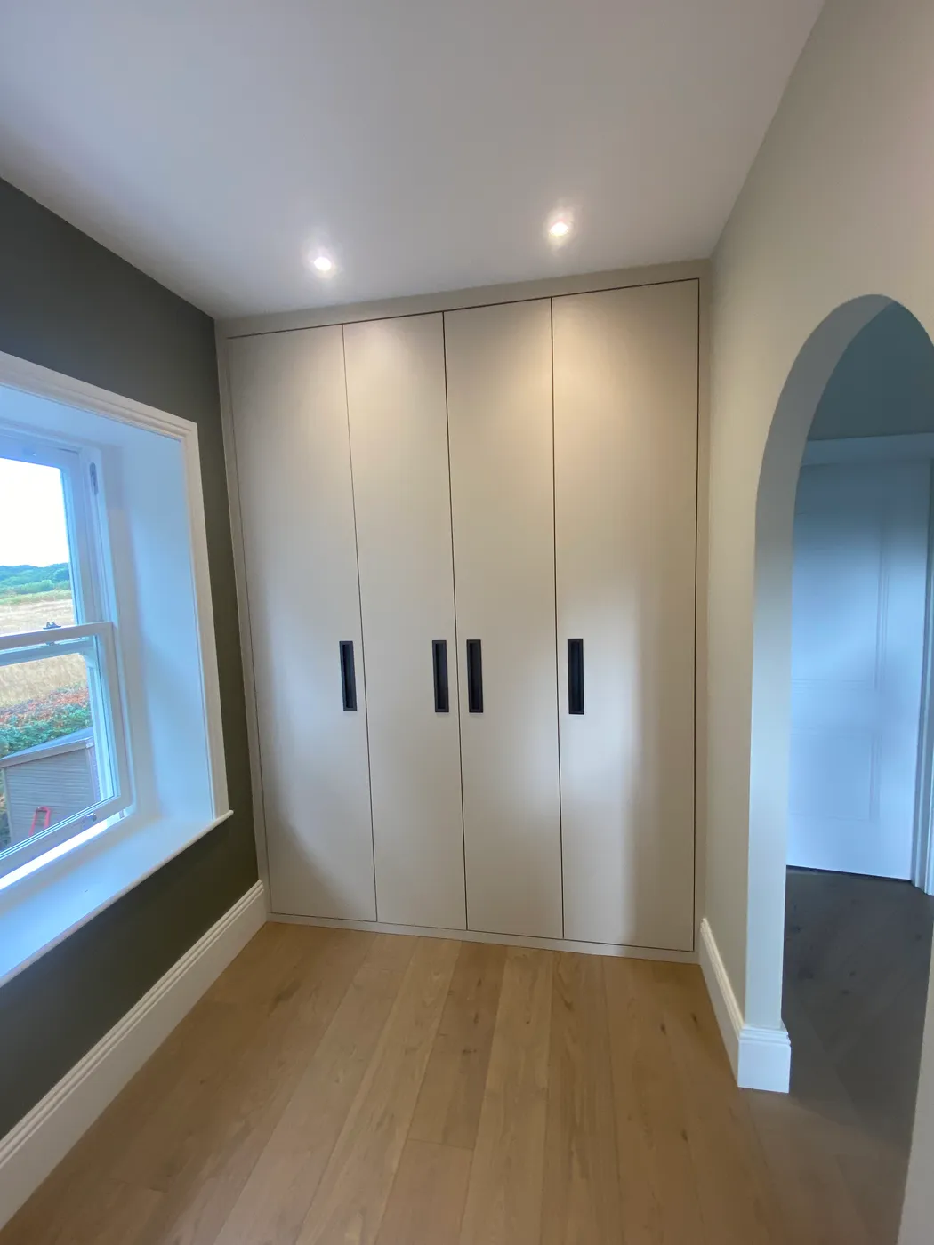 Bright bedroom with contemporary fitted wardrobes