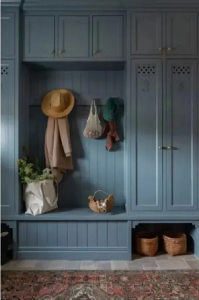 Dusty blue mudroom with numbered lockers