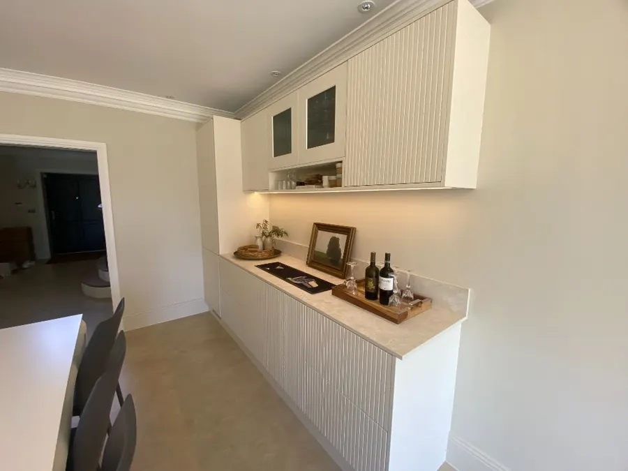Fluted cream bar angled toward the dining room