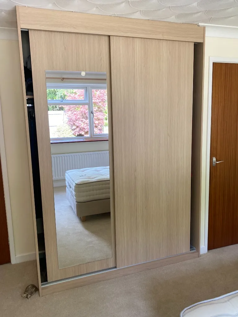 Light oak two-door sliding wardrobe with inset mirror panel